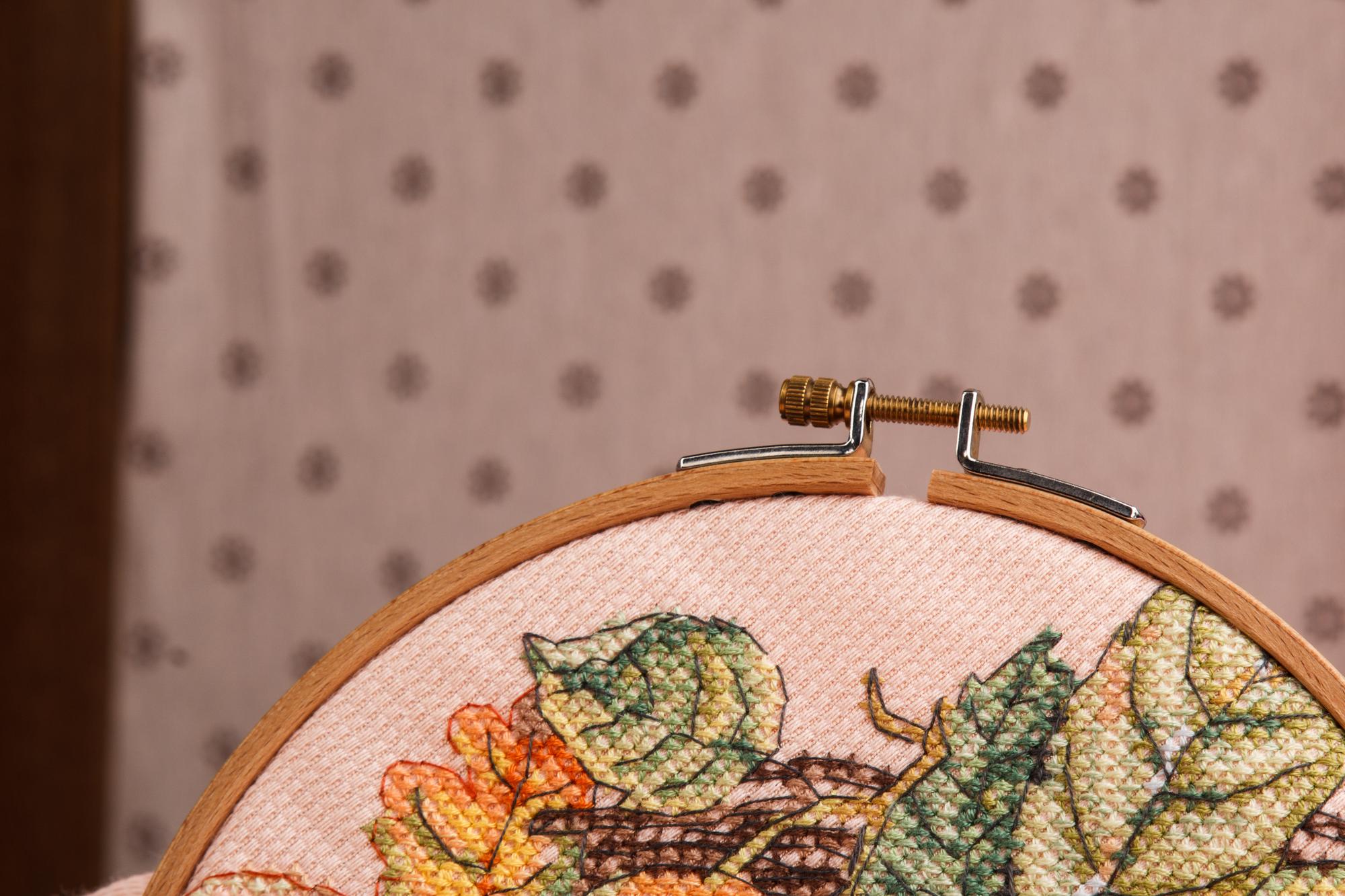 Restored embroidered panel displayed on neutral background